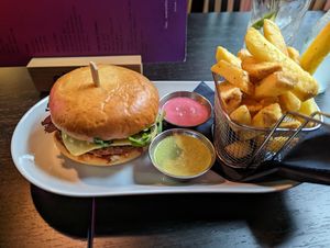 The Klandi burger with fries and green (herbs) and pink (like honey mustard) sauce at Klandestine in Basel