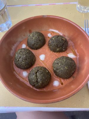 Palotte secondi: veggie and almond balls over tomato sauce with dollops of olive oil and vegan cheese  at L' Angolo Cottura in Rome