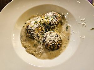 Spinach dumplings with blue cheese sauce at Tisch in Vienna