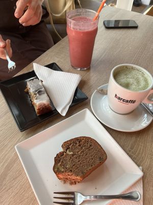 Slice of banana bread, slice of poppy lemon cake, matcha latte and berry smoothie  at Food Garden in Zagreb
