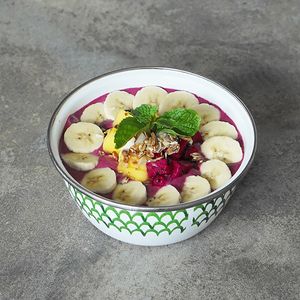 Red Dots Smoothie Bowl (GFO): dragon fruit, banana, peanut butter, and coconut water, topped with granola, banana, dragon fruit, and mango slices at Warung Dua Hati in Canggu