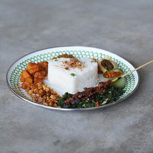 Nasi Campur Dua Hati: nasi campur with vegan protein, satay, mushroom, tempeh, greens, potatoes, spiced shredded coconut, and sambal of your choice at Warung Dua Hati in Canggu