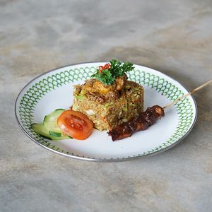 Nasi Goreng Special: wok-fried rice with our signature "rendang", satay, greens, topped with crispy kale chips at Warung Dua Hati in Canggu