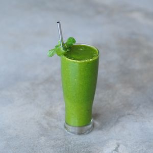 Dua Hati Protein Smoothie: kale, baby spinach, mango, plant-based vanilla protein, and coconut water at Warung Dua Hati in Canggu