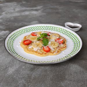 Protein Waffle: heart-shaped waffle infused with plant-based protein powder, topped with strawberry, banana, coconut flakes, served with coconut nectar at Warung Dua Hati in Canggu