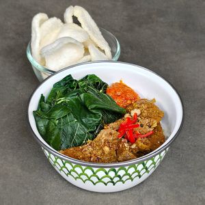 Padang "Beef" Rendang Bowl:	slow-cooked “beef” rendang simmered in coconut milk and traditional spices, white or red rice, spinach, and sambal merah, topped with crackers at Warung Dua Hati in Canggu