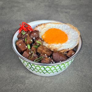 Sweet Soy “Pork” Rice Bowl: braised “pork” and potatoes in sweet soy sauce, served with white or red rice, topped with a sunny side up "egg", leek, and fresh red chilies at Warung Dua Hati in Canggu