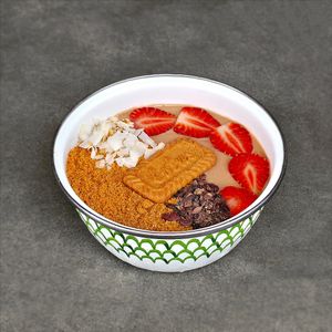 Lotus Biscoff Smoothie Bowl: a creamy blend of Lotus Biscoff spread, banana, cocoa, and oat milk, strawberries, crunchy Biscoff crumbs, cocoa nibs, coconut flakes, Biscoff Biscuit at Warung Dua Hati in Canggu