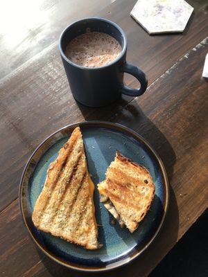 mushroom and vegan cheese toastie, hot chocolate with plant milk  at La Colona in Puerto Natales