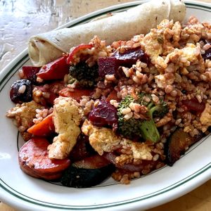 The vegan Chakra Khan! Onion, green peppers, mushrooms, broccoli, zucchini, carrots, roasted beets, kale, garlic, tofu, cashew spread, with tortillas. Damn, this was good!   at Modern Times Cafe in Minneapolis