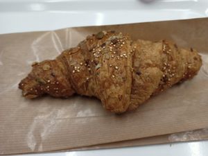 Croissant with cereal at Deli&Cia - OPO in Porto