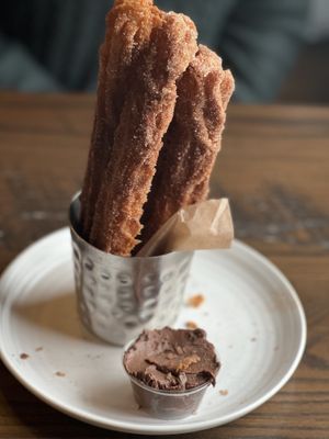 Warm churros with chocolate   at Besina in Providence