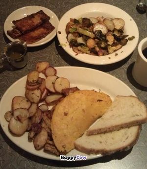 bottom: tofu omlette, breakfast potatoes, and toast; top: seitan chorizo and vegetable potato hash, side of tempeh bacon at Veggie Galaxy in Cambridge