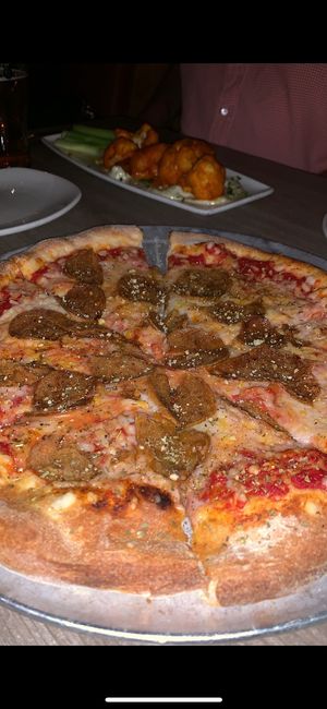 Vegan Pepperoni Pizza with Buffalo Cauliflower wings in the background at Mohawk Bend in Los Angeles