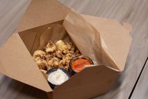 Buffalo Cauliflower packaged for delivery, with buffalo sauce on the side.  at Mohawk Bend in Los Angeles