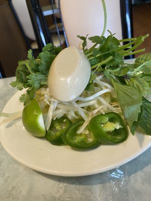 Accompaniments of spicy noodle soup  at Kim Phuong Vegetarian Delight in Renton