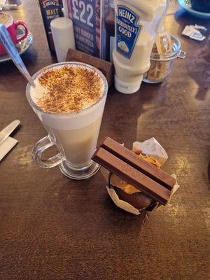 Chai latte and chocolate biscoff and vegan kitkat muffin. at Revo Kitchen & Terrace in Weston-super-mare