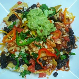 The star of the show, in my opinion: Vegan nachos with vegan "chicken." It's a tasty, beautiful disaster! at Olga's Naturally in Los Angeles