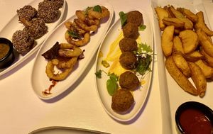 Breaded mushrooms, onion rings, falafel, & brava potatoes.   at Karavan in San Pedro De Atacama