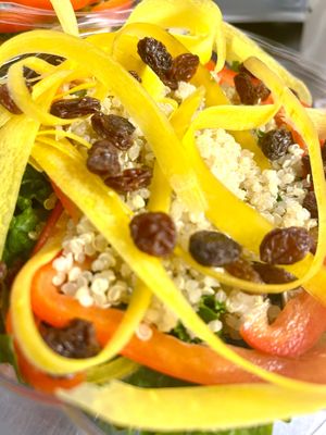 Kale and quinoa salad with red bell pepper, rainbow carrots, raisins, and almond tie dressing  at Botanika Cafe in Ridgefield