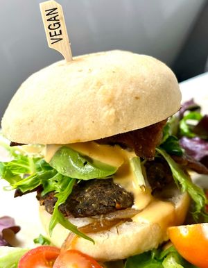 Botanika burger. House made veggie burger (3 beens, Hemp,  chia, pea protein), crispy lettuce, mashed avocado, slice of tomato, gluten free house made bun, adobo sauce.  at Botanika Cafe in Ridgefield
