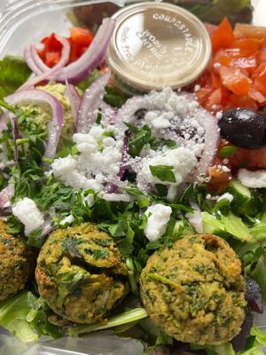 Falafel salad. House made gf falafel, pea hummus, tomato, cucumber, red onion, olives, feta, green leaves and tahini dressing  at Botanika Cafe in Ridgefield