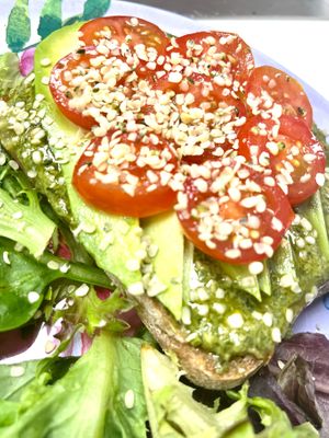 NEW! Pesto avocado sandwich with cherry tomato and hemp seeds. House made gluten free sourdough bread, house made basil pesto, avocado, tomato and hemp protein at Botanika Cafe in Ridgefield