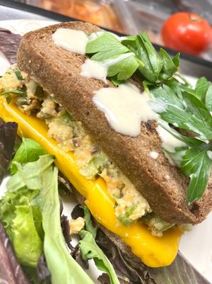 NEW! Melt tuna. House made gluten free sourdough bread, vegan cheese, delicious tuna with pickles, house made chickpea mayo and crispy lettuse  at Botanika Cafe in Ridgefield