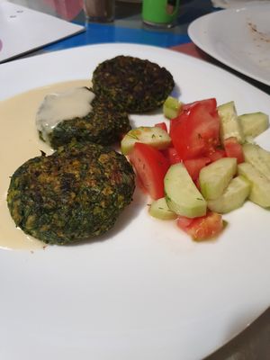 Spinach pâtés with salad and sauce at Dream House in Sofia