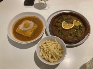 Francesinha and "duck" dish  at A Minha Avó in Lisbon