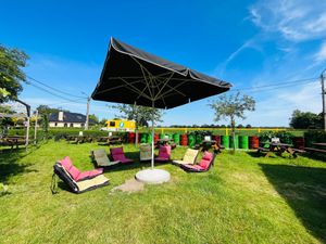 New addition to the terras, lounge seats and a big parasol! at De Biertuin in Ravels
