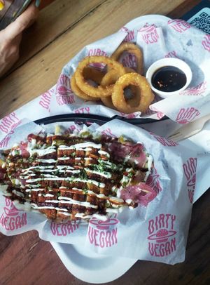 Loaded dirty fries with garlic 'chicken' and onion rings! Was both filling and super delicious. at Dirty Vegan - Barcode Street Food in Oslo