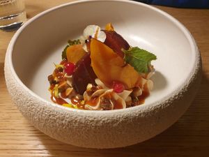 Roasted peaches dessert at MUDRA Plant Based  in Madrid