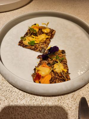 A cracker that was delicious at MUDRA Plant Based  in Madrid