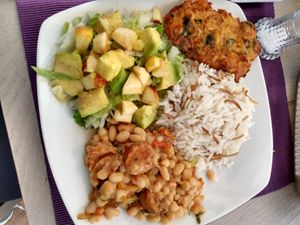 Rice with vermicelli, apple lettuce avocado salad, white beans with vegan sausage, fried potato and carrot fritter at Las Veganas in Medellin