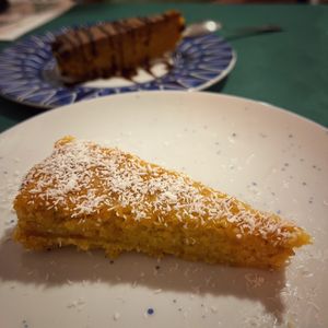 Vegan - The unforgettable pumpkin-coco cake
(behind, vegan carrot cake with fudge) at La Seda Veggie Kitchen Restaurante Vegetariano in Elche