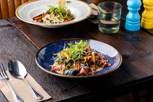 VEGAN CHARGRILLED EGG PLANT SALAD entrée and main size - roasted
aubergine, cherry tomato fregola salad garnished
with vegan mozzarella at Punk Pasta in London