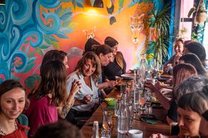 Guests dining upstairs on large party table at Kanu Poké in Shrewsbury