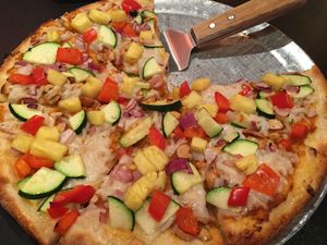 Vegan Cashew Thai Curry Pizza - with coconut red curry sauce, vegan cheese, zucchini, red pepper, cashews, cilantro, onion, fresh pineapple at Renee's Organic Oven in Tucson