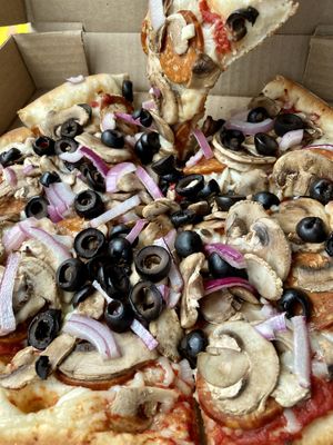 Build-your-own pizza with vegan mozzarella, vegan pepperoni, red onion, mushrooms, and black olives. 🍕  at Murphys Pizza Co in Murphys