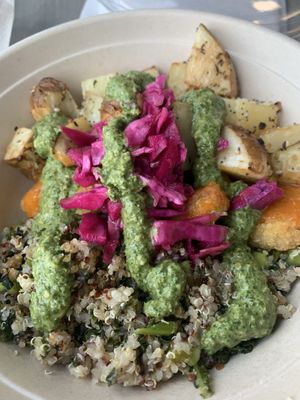 Everything potatoes, pesto drizzle, quinoa and kale base, Buffalo Impossible chicken, pickled cabbage.  at Florish in Tampa