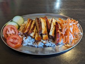 BBQ tofu served atop rice with a side of pickled daikon and carrots, and fresh cucumber+tomato. at Heart and Soy in Louisville