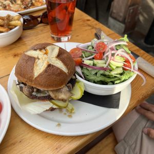 God-DAM Burger, impossible patty, no mayo, pretzel bun, add vegan cheese, sub green salad  at Amsterdam Cafe Pub in Whistler