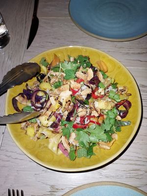 Pineapple salad with tons of veggies, coconut, and crispy rice at Girl & The Goat in Chicago