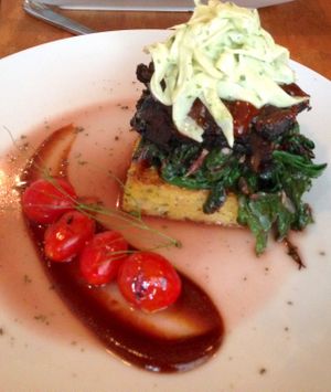 Polenta stacked with spinach and slaw was beyond delicious and I had leftovers the next day! at Plant in Asheville