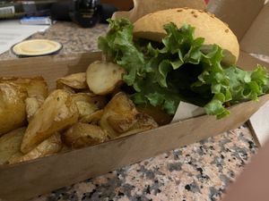The potatoes look good, but not taste good. The lettuce is brown on the edges. Very dry burger.  at Goiko in Barcelona