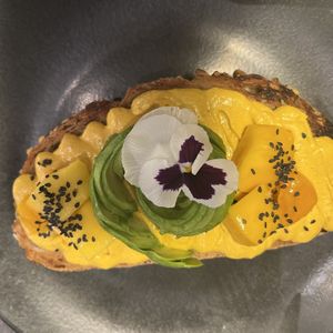 Delicious Mango Tango Toast with curry hummus & mango with an avocado rose 13,50  at The Avocado Show in Leidschendam