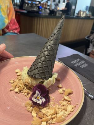 Delicious Peanut Butter Avo Ice Cream, vegan avo-peanutbutter ice serves with a black cone 5,95  at The Avocado Show in Leidschendam