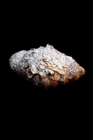 Boilled vanilla cream croissant, topped with almond slices and powder sugar at Foxy's Bake Shop in Riga