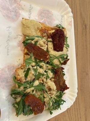 Cashew cream, rocket and sundried tomato pizza.  at La Prezzemolina in Rome